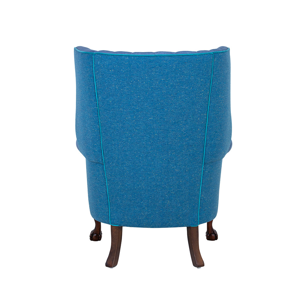 back of a blue wingbacked chair from brights of nettlebed